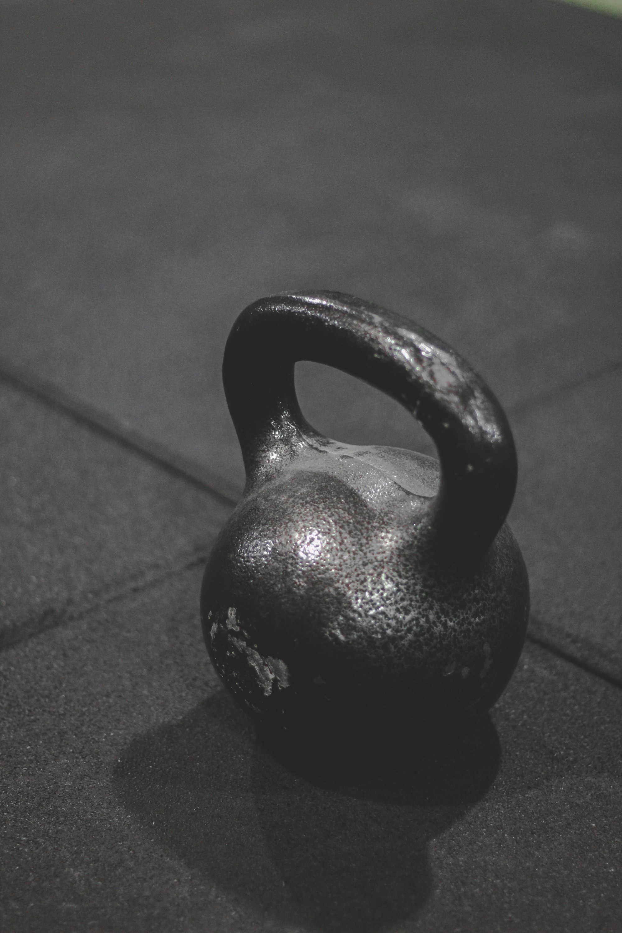 Cast-iron kettlebell on a dark rubber floor